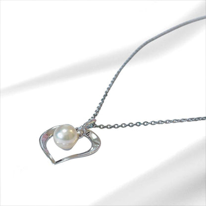 Mikimoto pearl necklace with silver heart pendant and 37 cm Akoya pearls on white background
