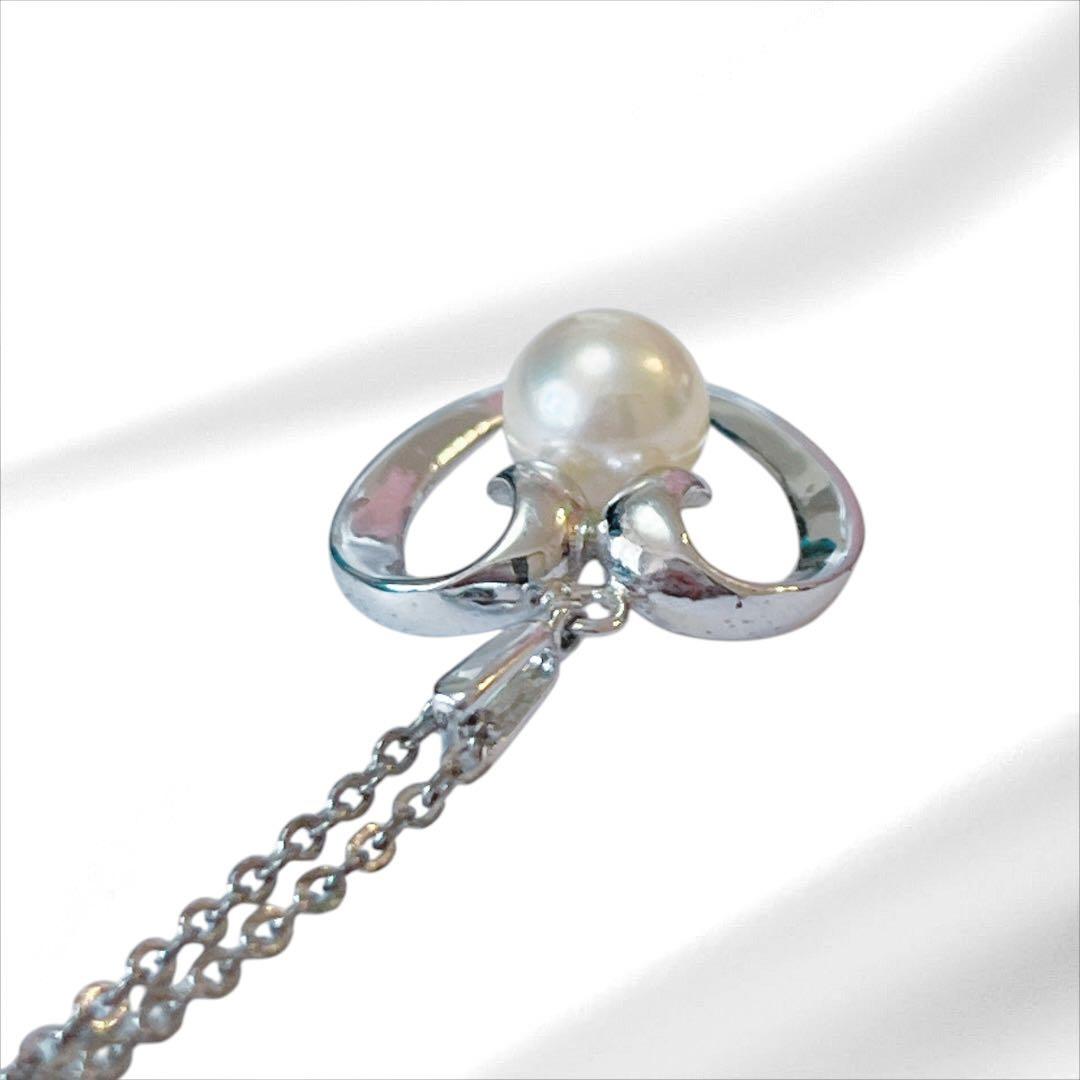 Mikimoto pearl necklace with silver heart pendant and 37 cm Akoya pearls on white background