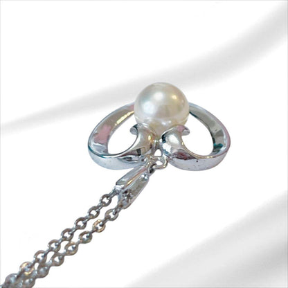 Mikimoto pearl necklace with silver heart pendant and 37 cm Akoya pearls on white background