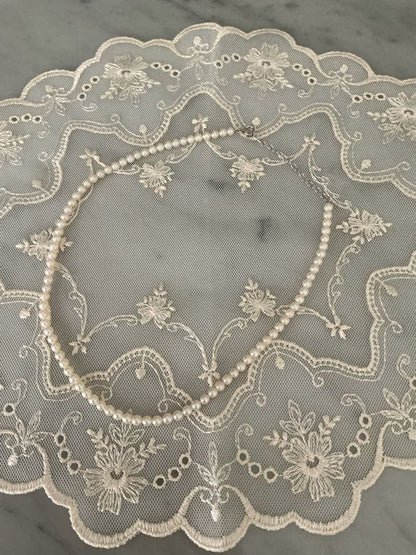 Tasaki K18WG freshwater pearl necklace with 43cm length and 3.5-4mm white pearls on white background