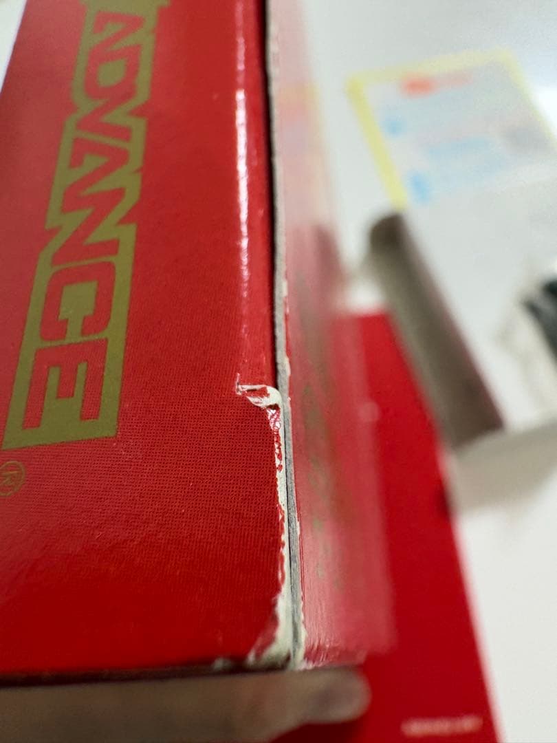 Game Boy Advance MOTHER3 game cartridge with original box and manual showing signs of aging and storage damage
