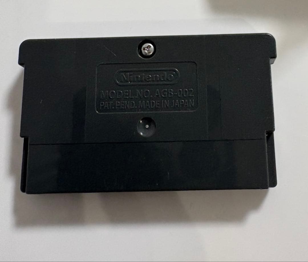 Game Boy Advance MOTHER3 game cartridge with original box and manual showing signs of aging and storage damage