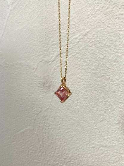 10K gold necklace with a pink agate diamond-shaped pendant measuring 9 mm stone and 13 mm top size