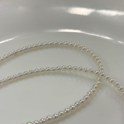 Uncolored Akoya pearl necklace with 3-3.5mm baby pearls and 42cm length featuring a 925 clasp