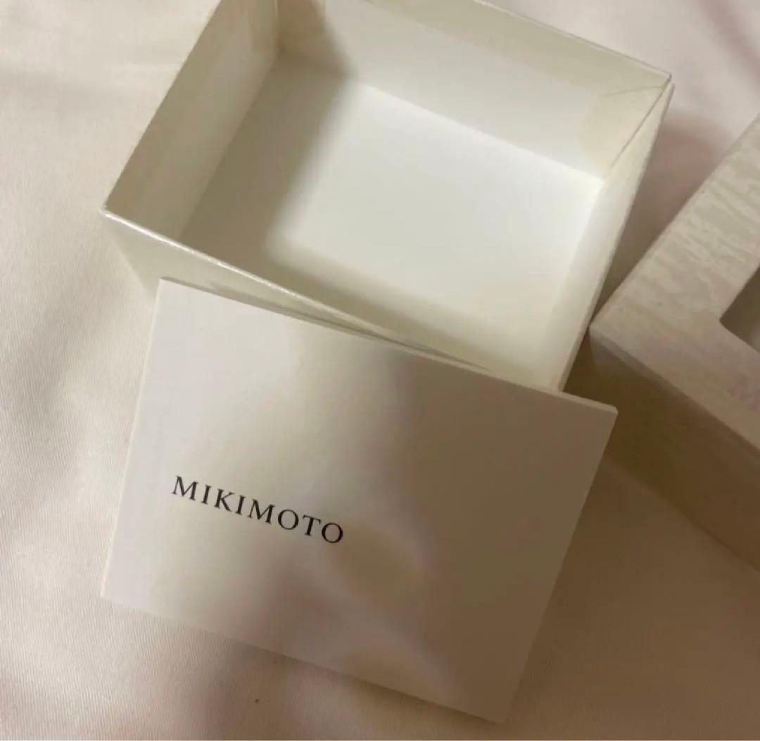 Mikimoto pearl necklace featuring a silver pendant displayed with its box
