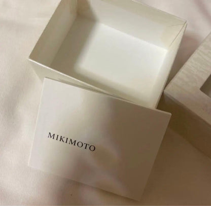 Mikimoto pearl necklace featuring a silver pendant displayed with its box