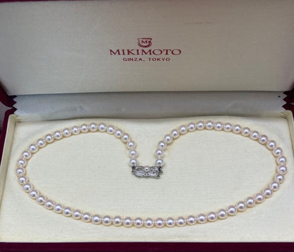 Mikimoto baby pearl necklace with 6 to 6.5 mm pearls, silver clasp engraved Mikimoto, displayed with case