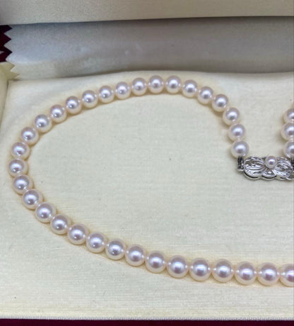 Mikimoto baby pearl necklace with 6 to 6.5 mm pearls, silver clasp engraved Mikimoto, displayed with case