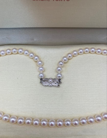 Mikimoto baby pearl necklace with 6 to 6.5 mm pearls, silver clasp engraved Mikimoto, displayed with case