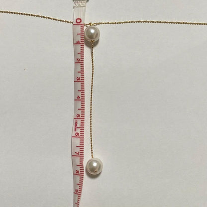 K18YG Akoya Pearl Y-shaped Necklace with cut ball chain and two Akoya pearls, one movable, on white background