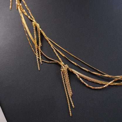 Agete 5-row gold necklace with long adjustable chain showing its length and clasp