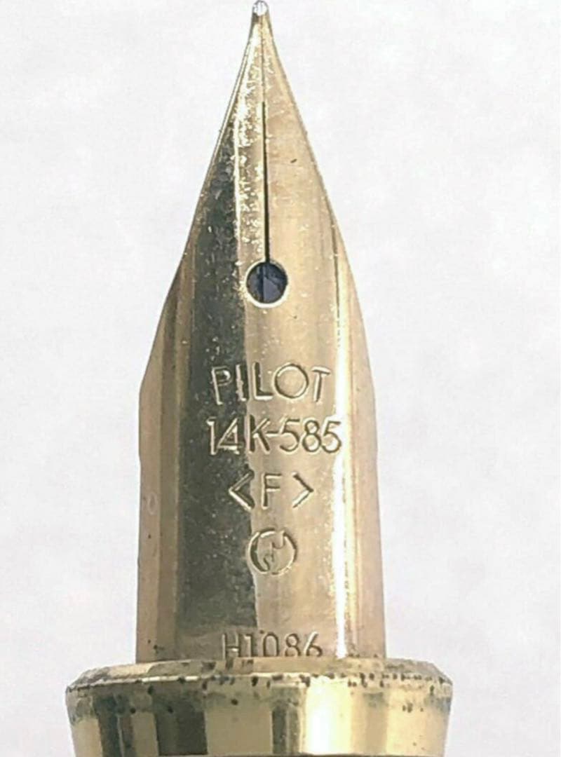 Pilot fountain pen with 14K gold fine nib, sleek black barrel, and silver clip made in Japan