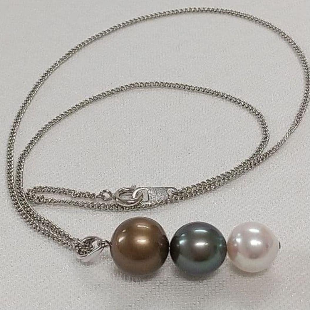 Law pendant with three round Tahiti black and Akoya pearls in varying colors on a service chain