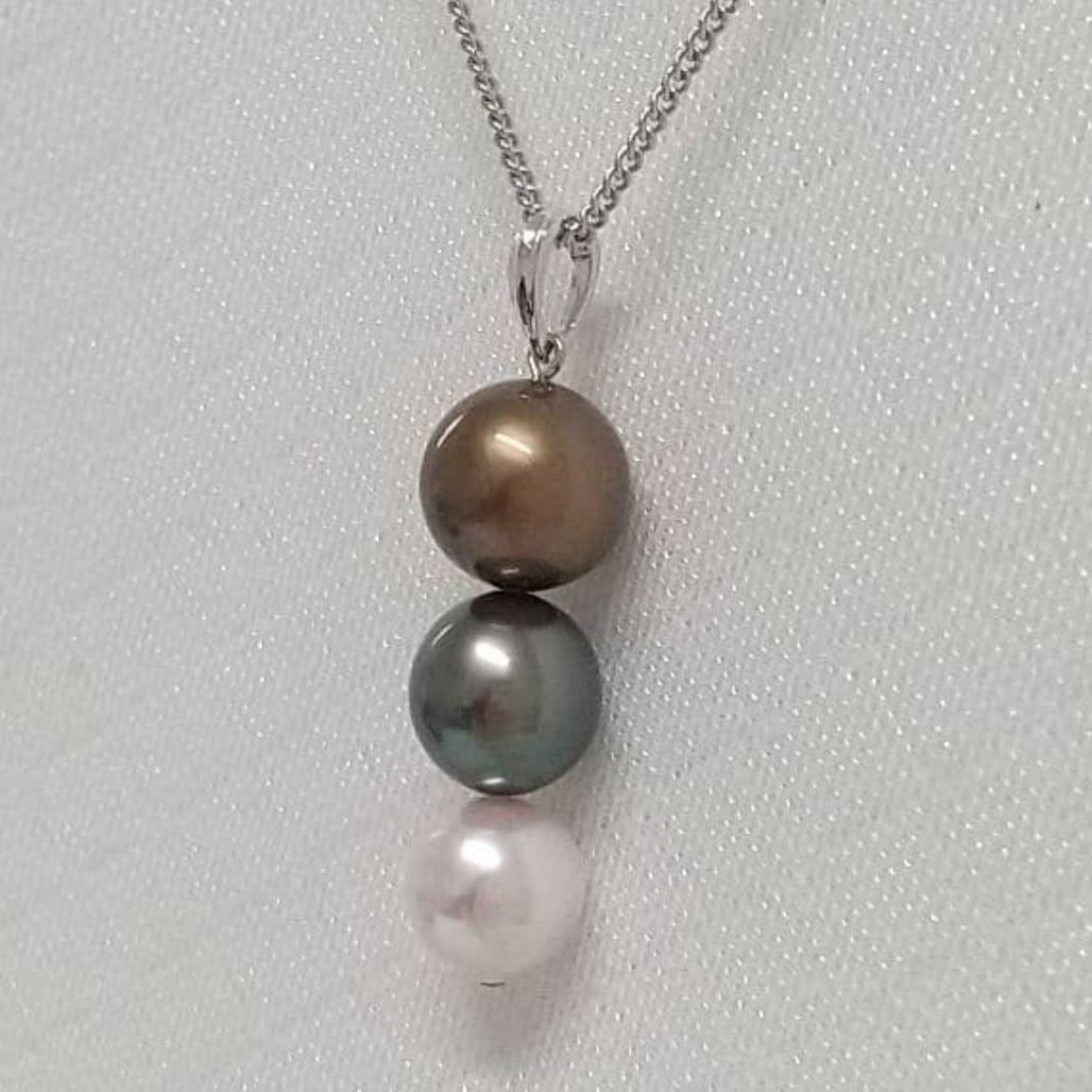 Law pendant with three round Tahiti black and Akoya pearls in varying colors on a service chain