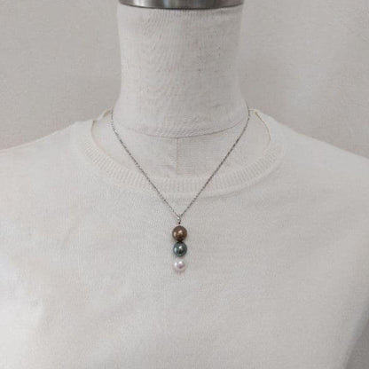 Law pendant with three round Tahiti black and Akoya pearls in varying colors on a service chain