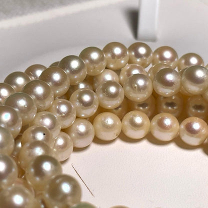 Akoya pearl long necklace with round white pearls 6.9-7.4mm in tsumami style on a silvery chain