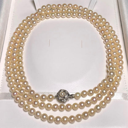Akoya pearl long necklace with round white pearls 6.9-7.4mm in tsumami style on a silvery chain