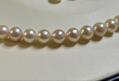 Akoya pearl necklace and matching earrings set with a 43 cm necklace length displayed on a white background