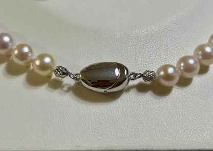 Akoya pearl necklace and matching earrings set with a 43 cm necklace length displayed on a white background