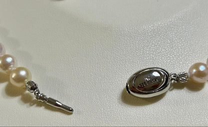 Akoya pearl necklace and matching earrings set with a 43 cm necklace length displayed on a white background