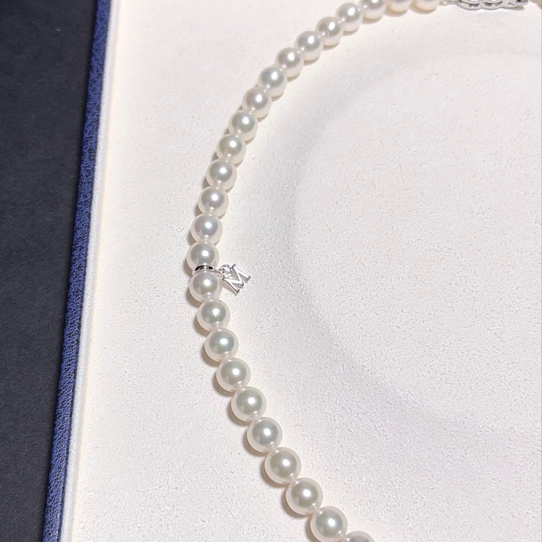 Mikimoto Akoya Pearl Necklace with 7.0 mm pearls and charm, 42cm length, displayed on white background