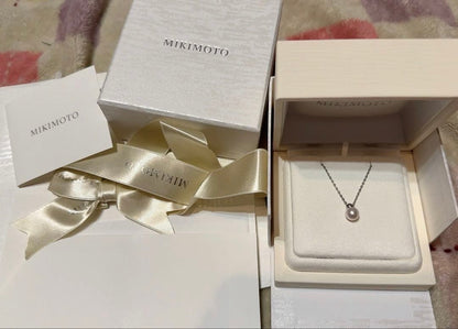 Mikimoto Pearl Pendant Necklace with simple design and adjustable chain displayed with gift box and ribbon