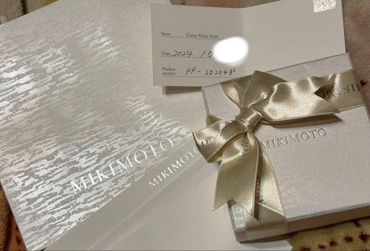 Mikimoto Pearl Pendant Necklace with simple design and adjustable chain displayed with gift box and ribbon