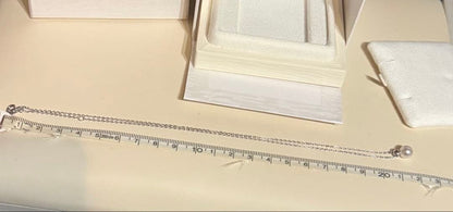 Mikimoto Pearl Pendant Necklace with simple design and adjustable chain displayed with gift box and ribbon