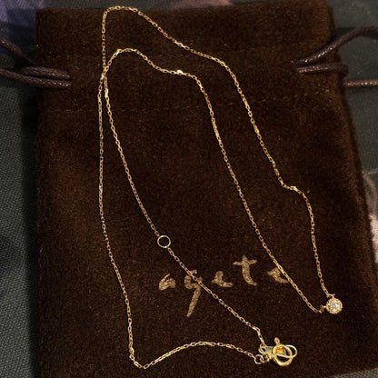 Agete K18 yellow gold necklace with millegrain diamond accents and single Akoya pearl on adjustable 40 cm chain