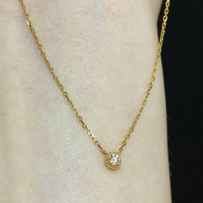 Agete K18 yellow gold necklace with millegrain diamond accents and single Akoya pearl on adjustable 40 cm chain
