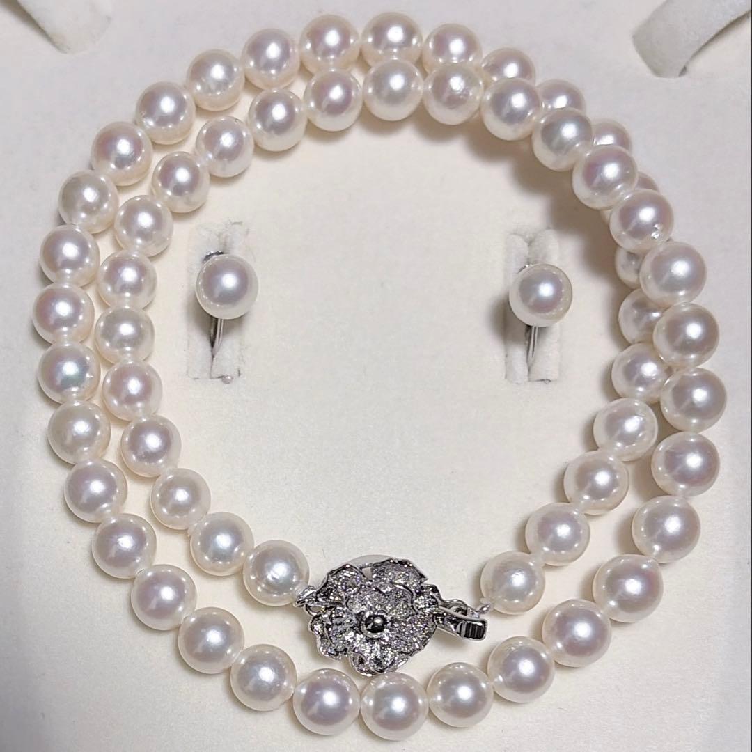 Akoya pearl necklace and matching earrings set with K14WG and silver clasps on white background