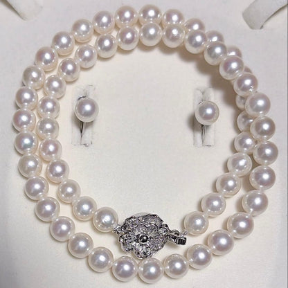 Akoya pearl necklace and matching earrings set with K14WG and silver clasps on white background
