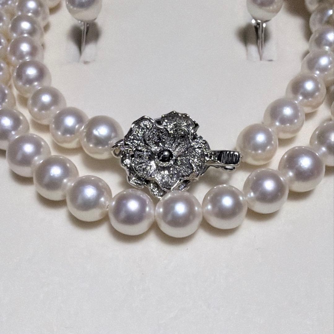 Akoya pearl necklace and matching earrings set with K14WG and silver clasps on white background