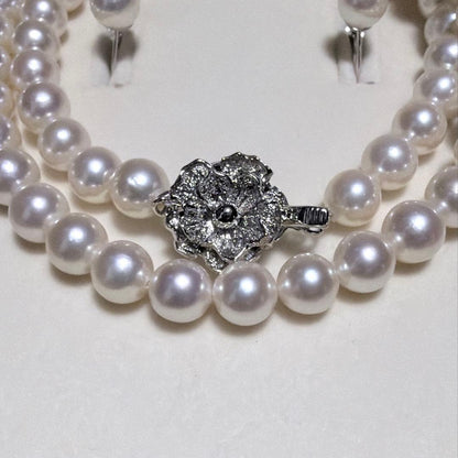 Akoya pearl necklace and matching earrings set with K14WG and silver clasps on white background