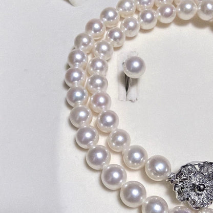 Akoya pearl necklace and matching earrings set with K14WG and silver clasps on white background