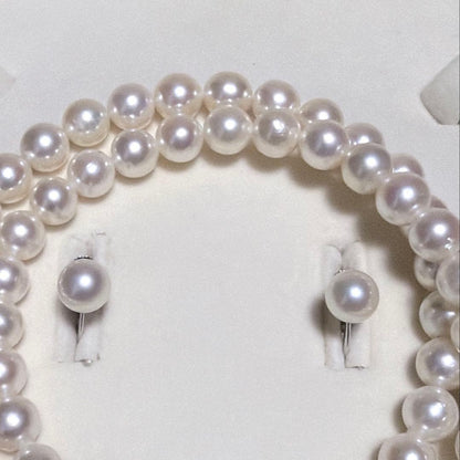 Akoya pearl necklace and matching earrings set with K14WG and silver clasps on white background