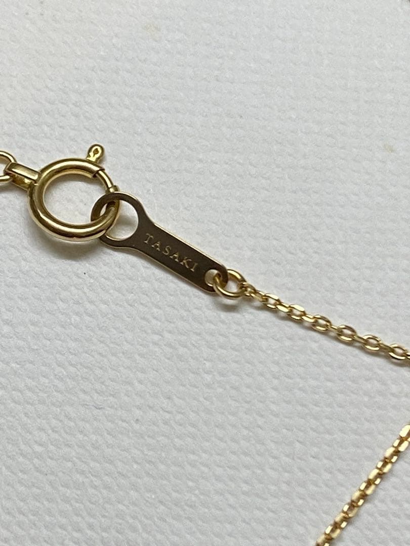 Tasaki K18 gold necklace featuring an 8mm Akoya pearl and a small diamond on a koza chain