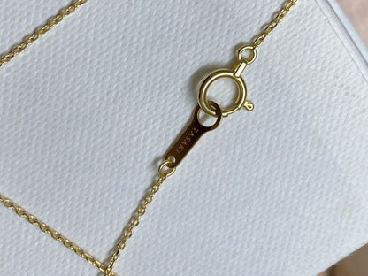 Tasaki K18 gold necklace featuring an 8mm Akoya pearl and a small diamond on a koza chain