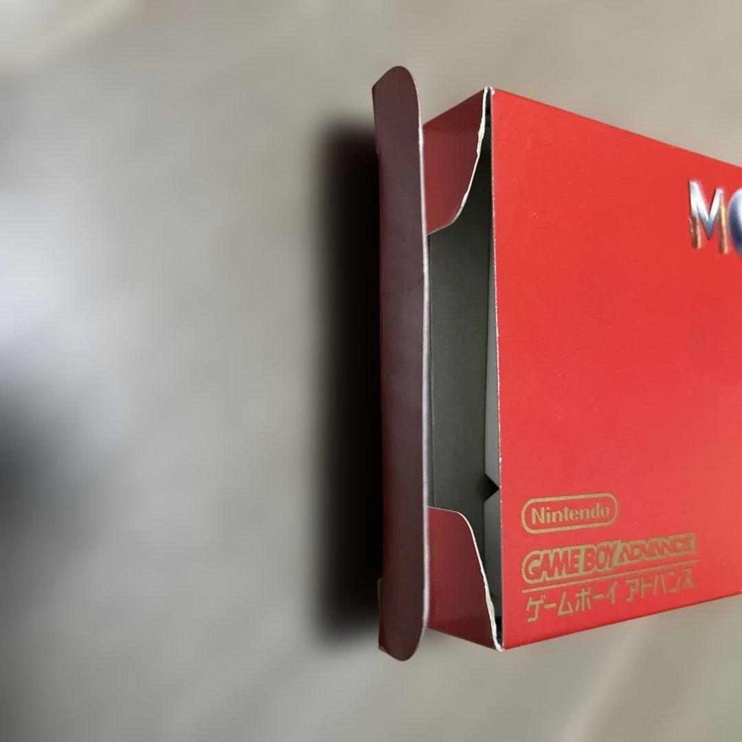 Game Boy Advance MOTHER3 game cartridge with original box and manual showing wear and aging signs