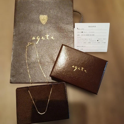 K18 gold necklace with 0.04ct diamond pendant by agete, model 10174116089, on white background