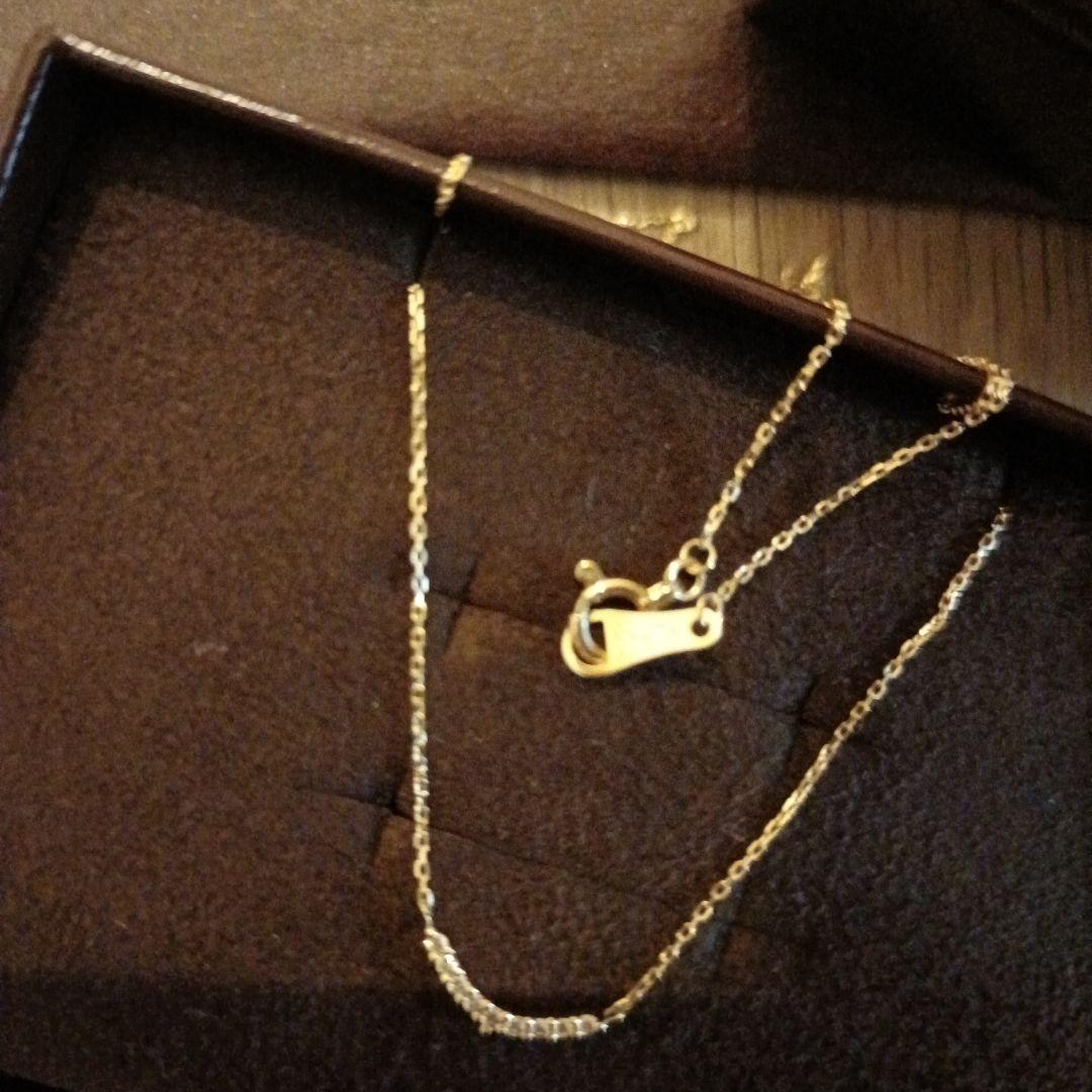 K18 gold necklace with 0.04ct diamond pendant by agete, model 10174116089, on white background