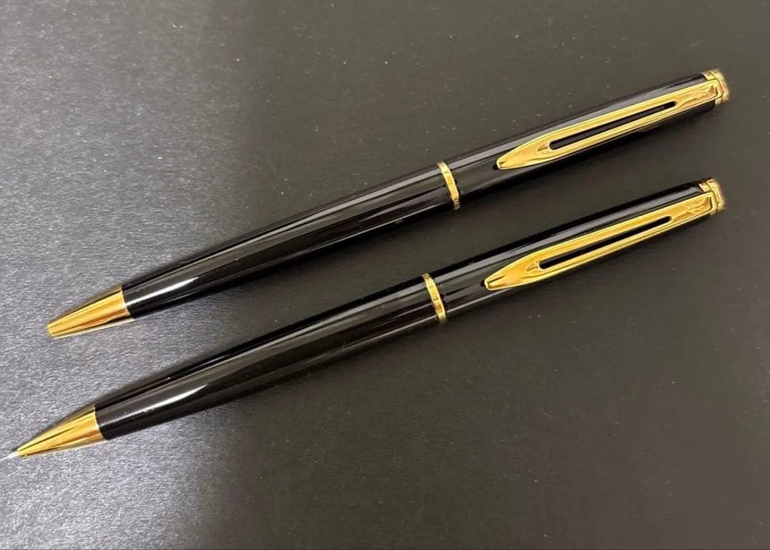 WATERMAN black ballpoint pen and mechanical pencil set with gold accents on a white background