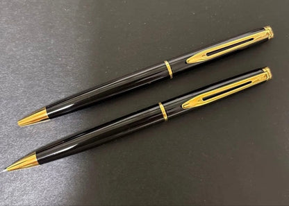 WATERMAN black ballpoint pen and mechanical pencil set with gold accents on a white background