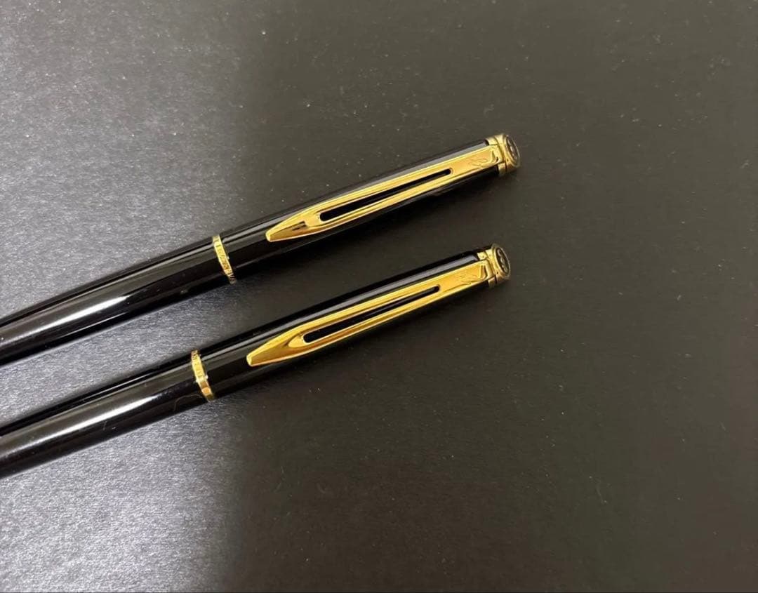 WATERMAN black ballpoint pen and mechanical pencil set with gold accents on a white background