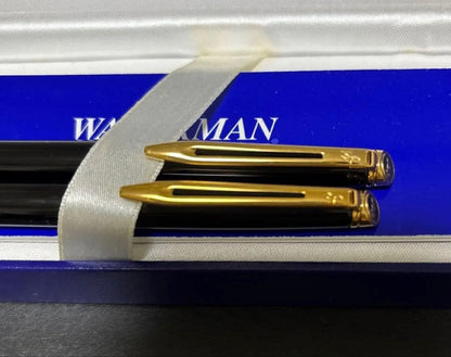 WATERMAN black ballpoint pen and mechanical pencil set with gold accents on a white background