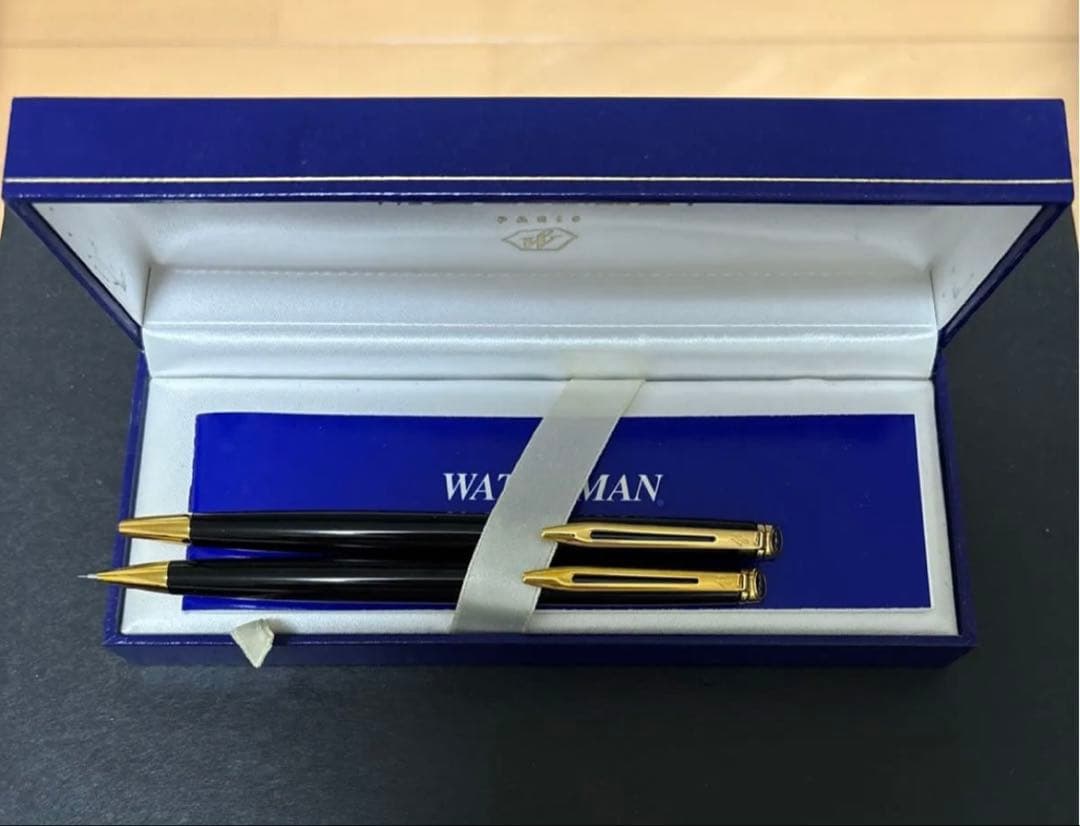 WATERMAN black ballpoint pen and mechanical pencil set with gold accents on a white background