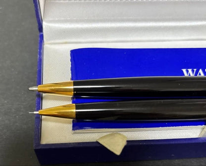 WATERMAN black ballpoint pen and mechanical pencil set with gold accents on a white background
