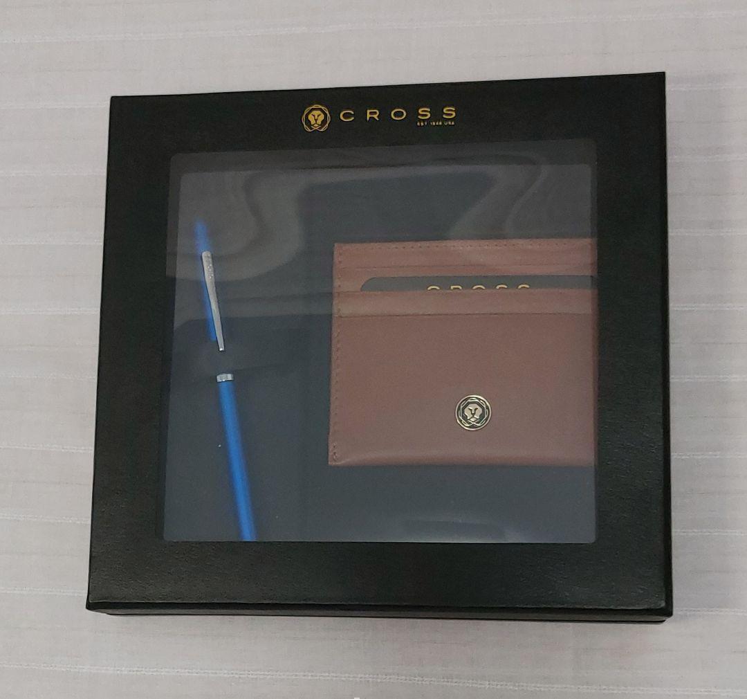 Cross ballpoint pen with blue brass resin body and chrome details alongside a brown leather card case