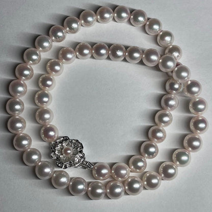 Akoya pearl necklace with 7.5-8.0mm pink white pearls and silver clasp on a white background