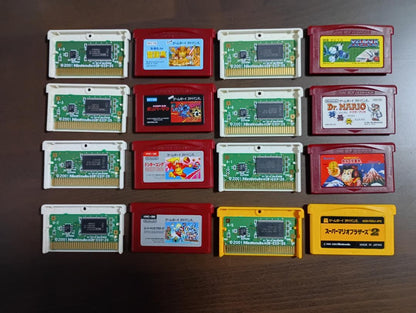 Famicom Mini Advance console with 8 classic game cartridges including Takahashi Meijin's Adventure Island and Bomberman